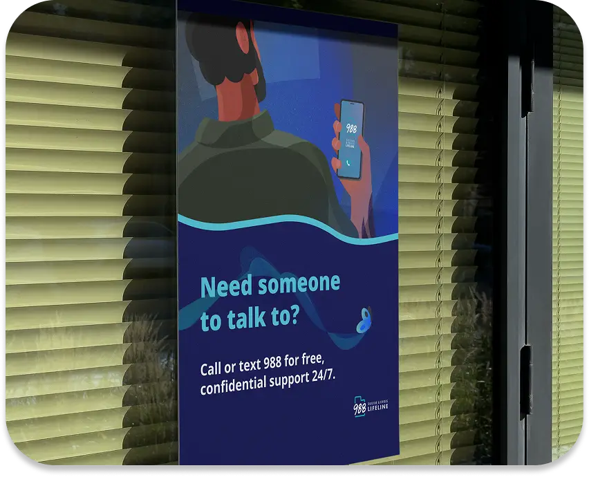 988 poster displaying a man accessing the 988 app on his phone