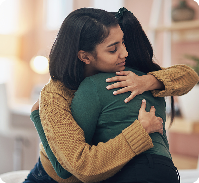 two persons who are hugging each other
