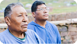 two middle-aged persons sitting next to each other looking away