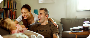 two persons that are smiling and looking at a child