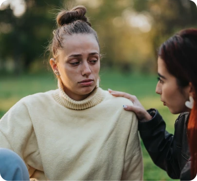 a sad person who is counselled by another person