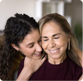 two persons hugging from behind