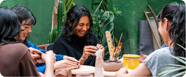 four persons that are having a pleasant time while doing art crafting together